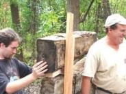 people building cabin wall