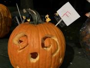 Carved pumpkin, spiral carved eyes, squiggle mouth, circle carved nose