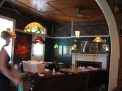 Dining room old, classic dining room; wood tables, white fire place, green walls, elaborate wood ceiling
