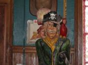 Rogues Harbor Inn--A rogue Pirate dressed in green, with black pirate hat with cross bones and a parrot and eye patch